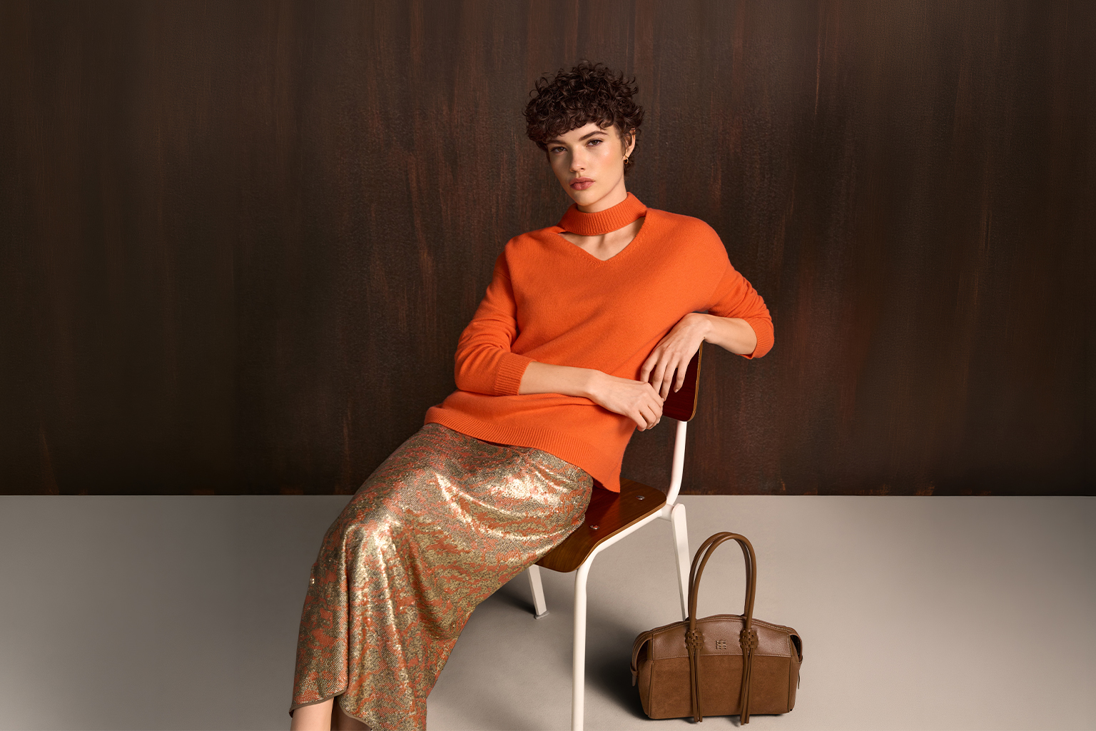 orange sweater, cutout collar, long sleeve, metallic skirt, brown handbag